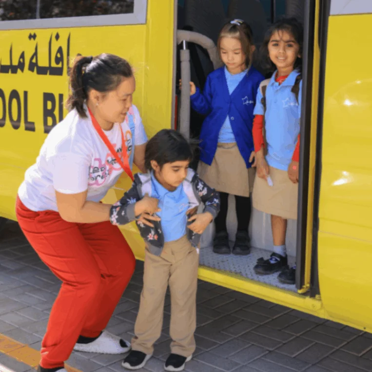 Students boarding a school bus at Star International School Mirdif